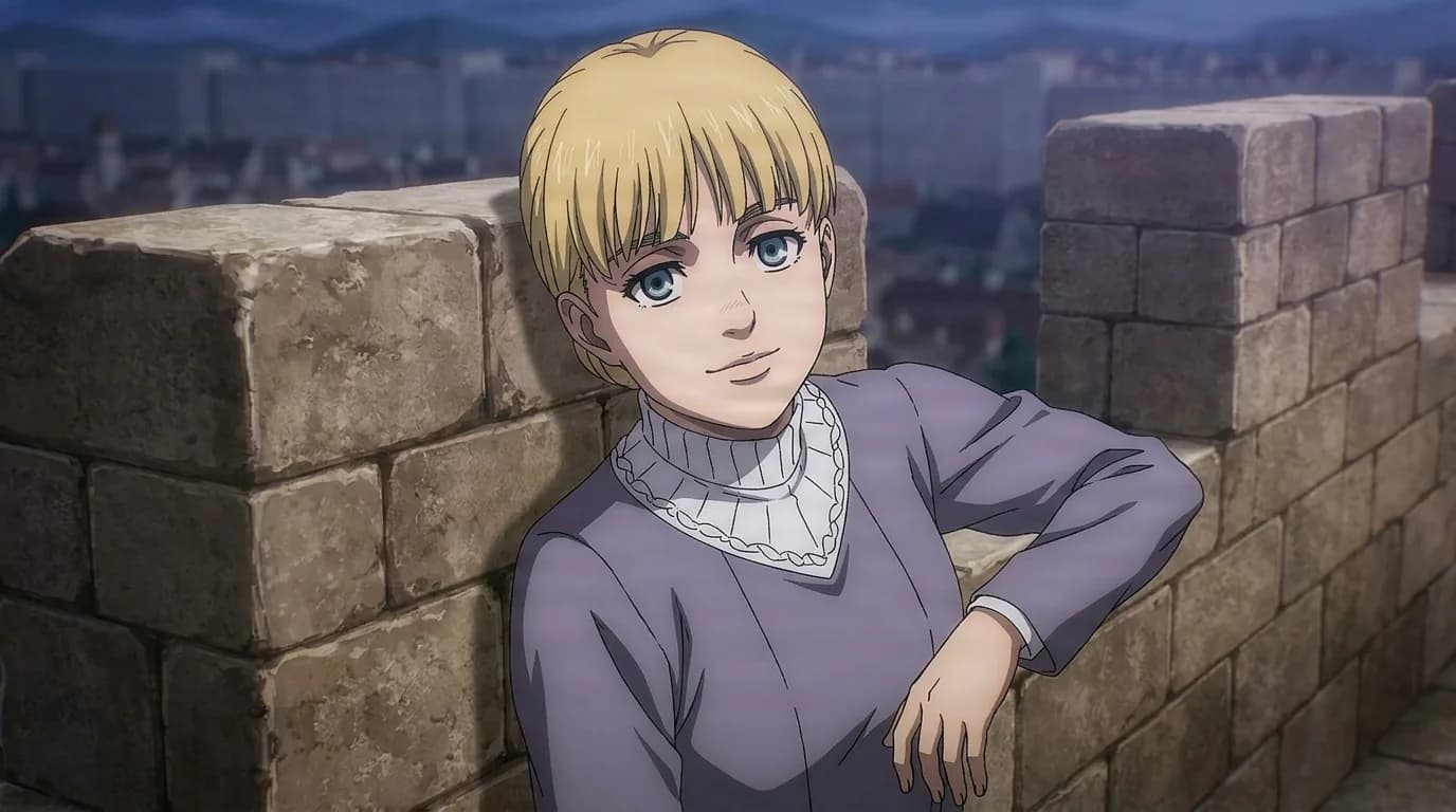 Fine Tybur, a blonde boy leaning against a stone wall, smiling over a walled city at dusk