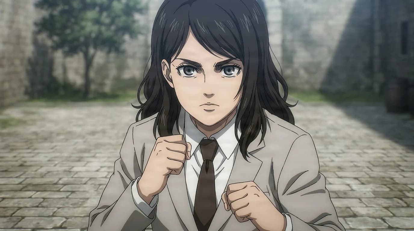 Finger, a dark-haired young woman in a grey blazer and tie, fists raised defensively in a stone courtyard