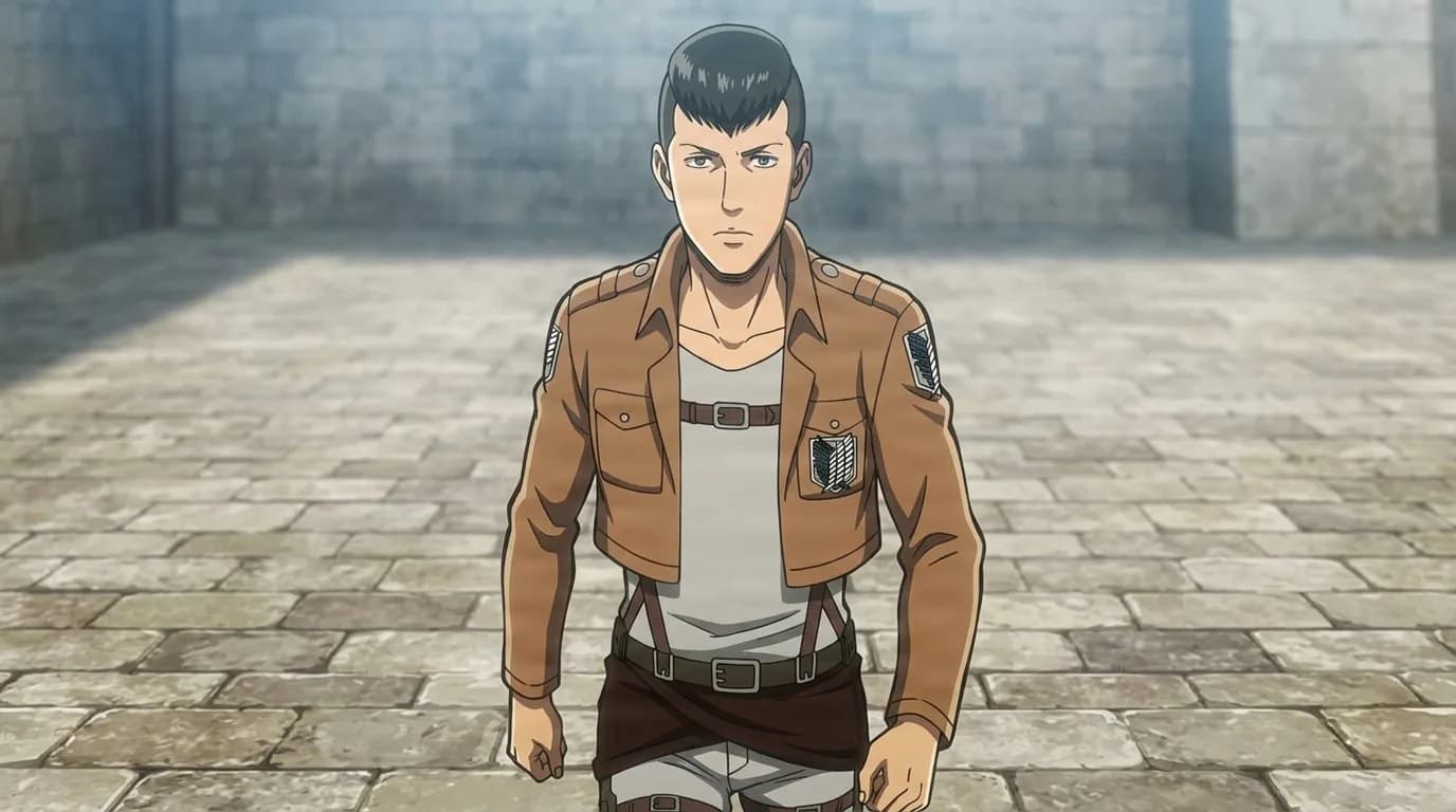 Gordon standing in a stone courtyard in the brown Survey Corps jacket and harness, short dark hair and a flat stare