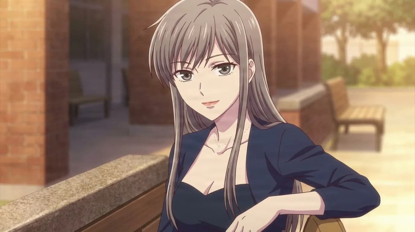 Ayame and Yuki's mother, a woman with long ash-brown hair and grey eyes in a navy blouse, resting an arm on a stone ledge outside a brick building