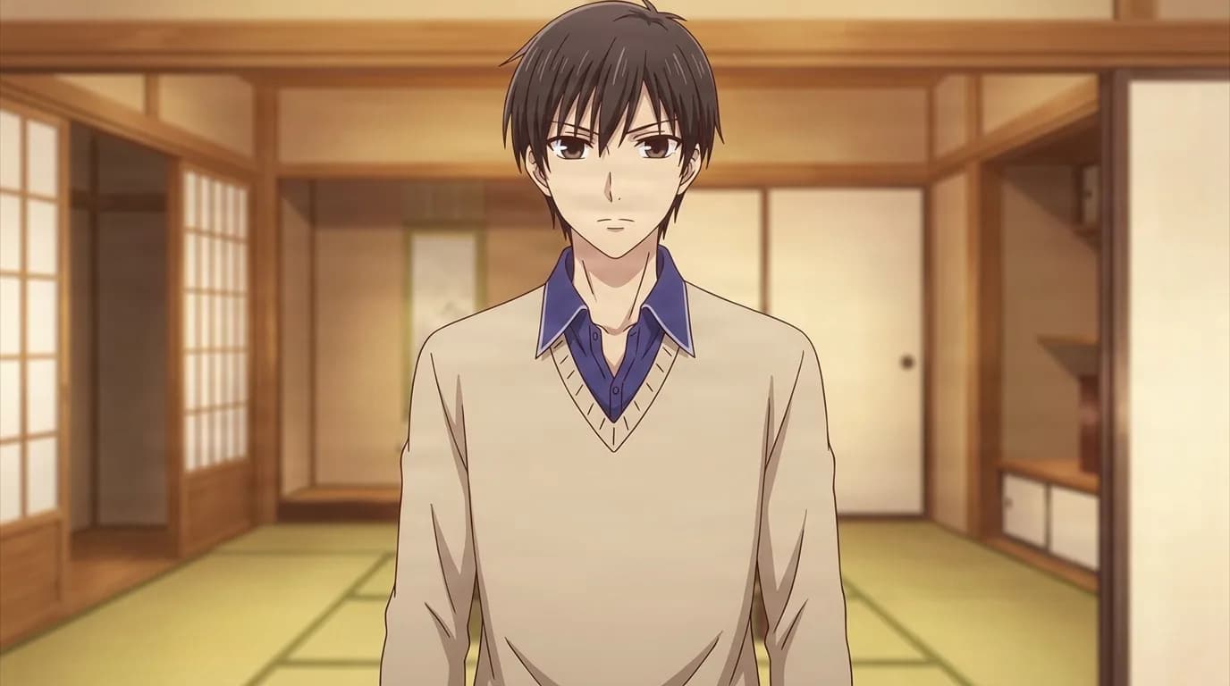 Kakeru Manabe in a beige sweater over a blue collared shirt, dark hair falling across his eyes, standing in a tatami room with paper screens