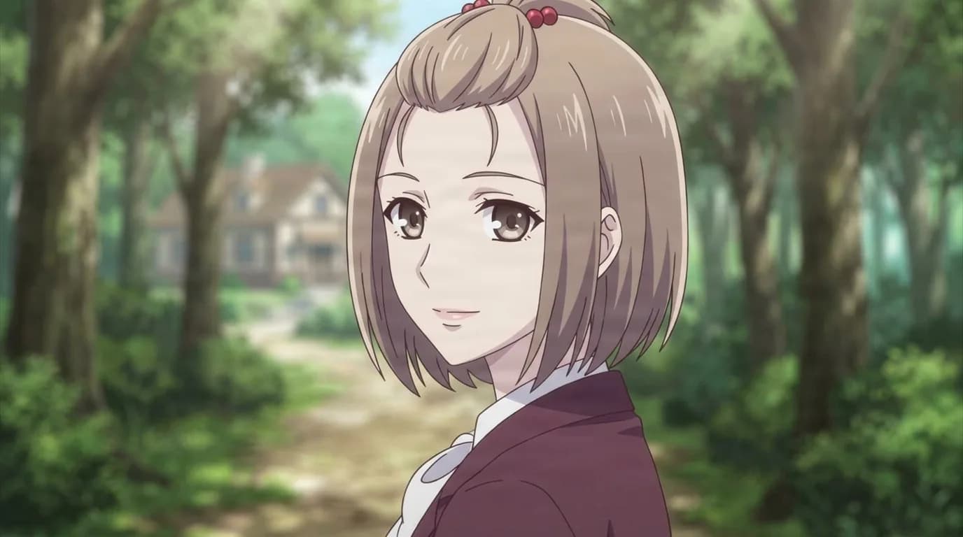 Kana Sohma with a short light brown bob tied in a small ponytail, wearing a maroon jacket over a white blouse, smiling on a wooded path