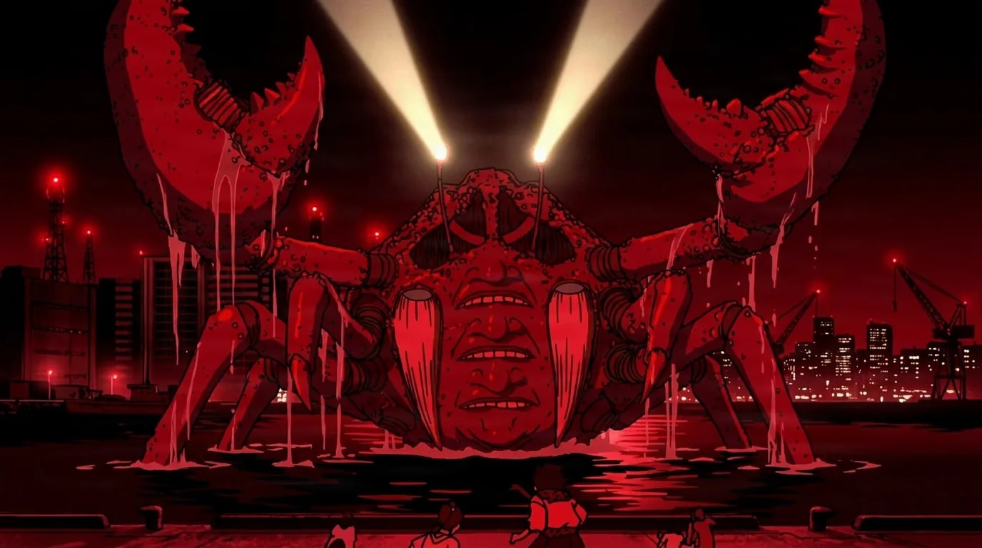 A colossal red crab monster with a wrinkled human face and glowing searchlight eyes rears up out of dark harbor water at night, its two huge claws raised above a red lit city skyline while tiny people watch from below.