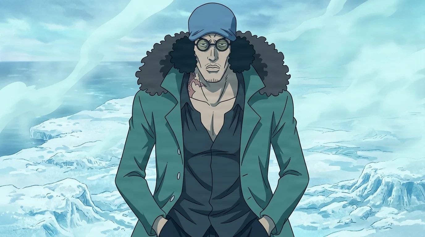 Tall man with a blue sleep mask on his forehead and small round glasses stands with hands in the pockets of his teal coat, a weary look on his face, on a frozen icy shore scattered with icebergs.